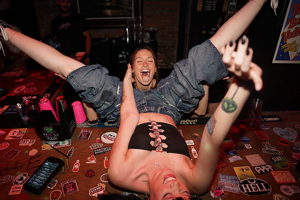 Upside down on the bar, mid-laugh