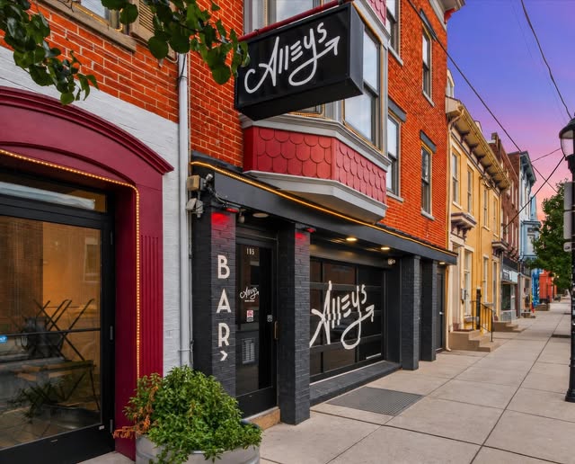 The black Alleys storefront with its script sign on South Duke Street